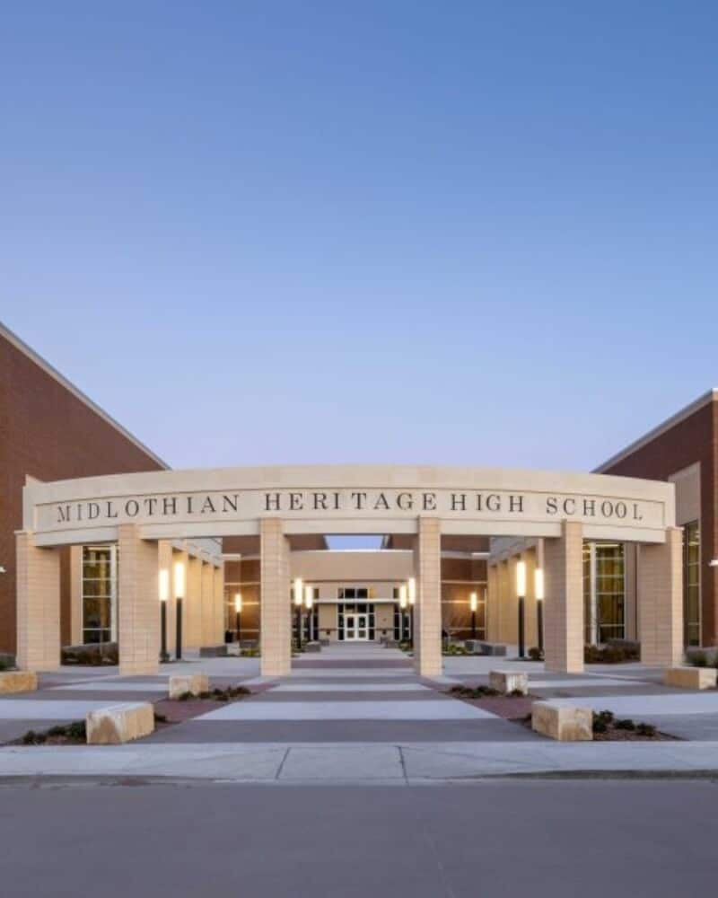 Facade of midlothian heritage high school at twilight.